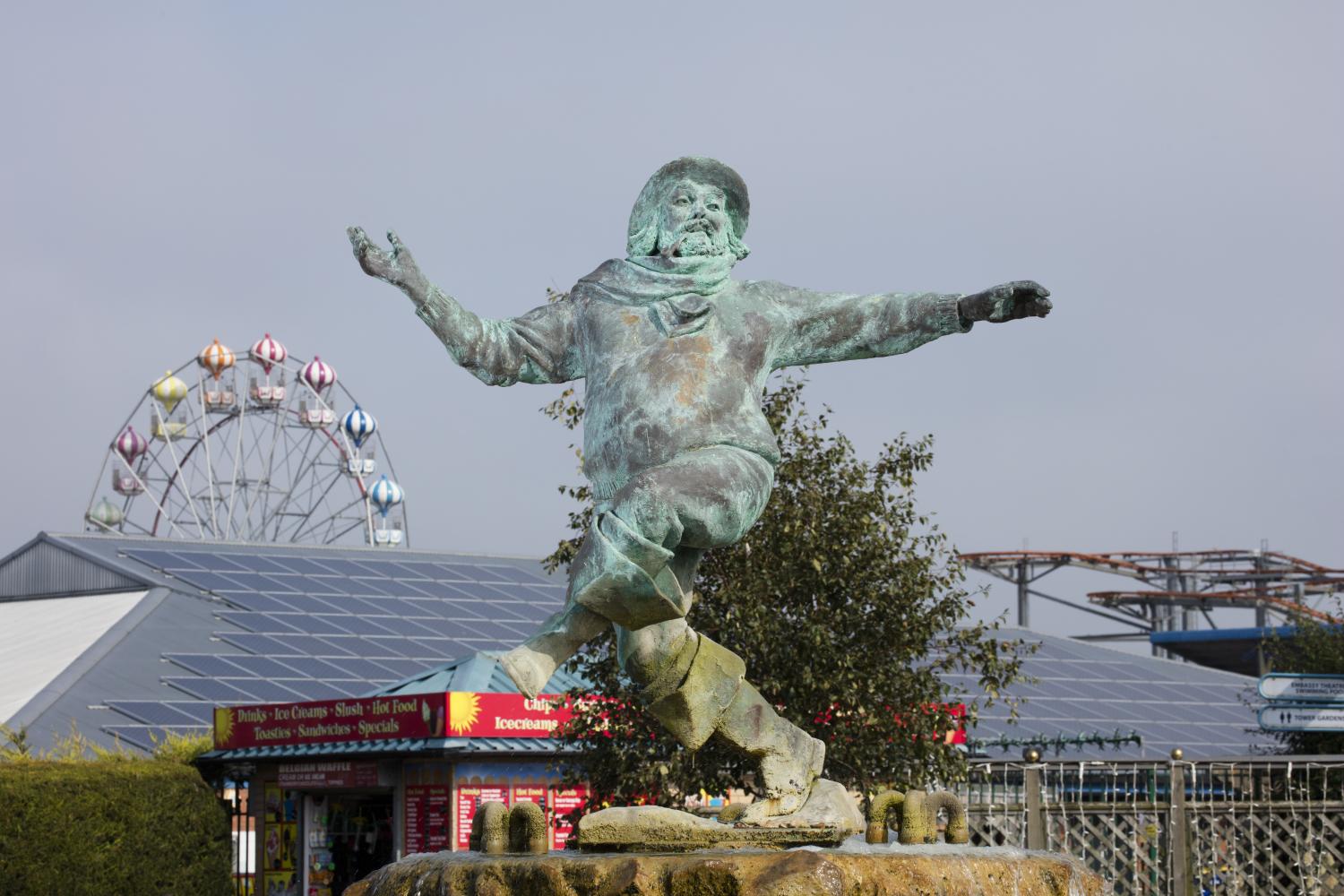 /localA statue in front of a ferris wheel