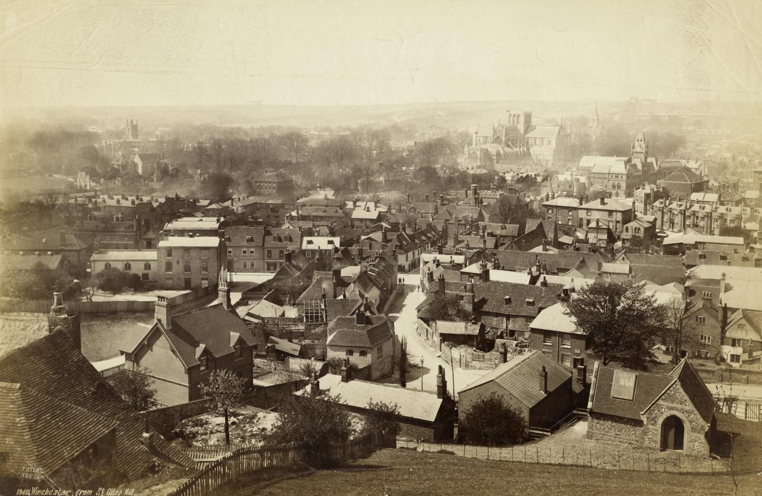 /localA historic photograph with a town and church