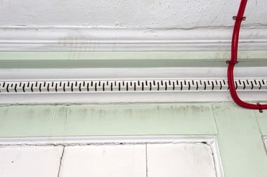 image showing an example of a cable running over the plaster coving, something that should be avoided