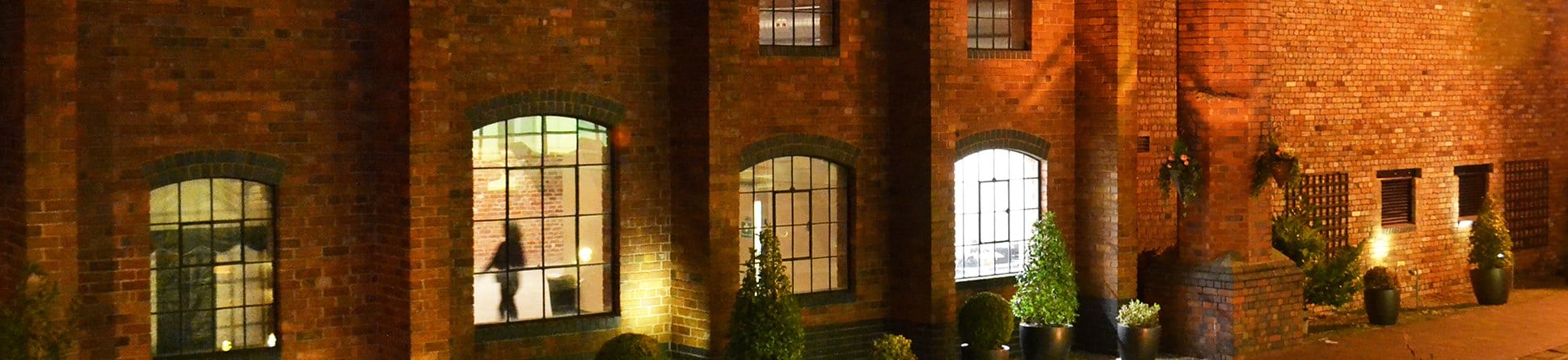 Photo of the outside of Gas Retort House at night