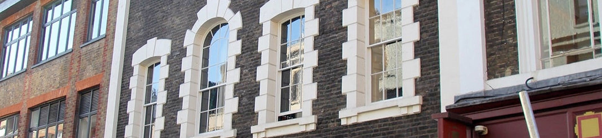 Georgian building with rusticated window surrounds.
