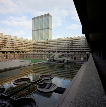 View of the Barbican estate in London showing Speed House and Willoughby House with a view of the lake in the foreground.