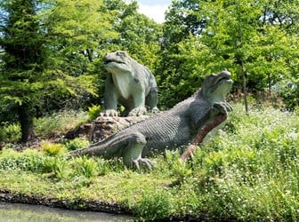 Two Iguanodon on a grassy bank