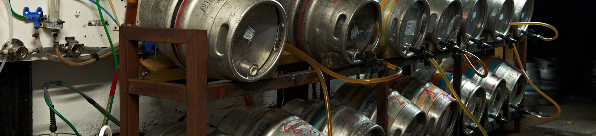 Rows of beer kegs stored in the back of a pub