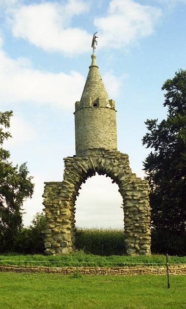 Archway made of stones with a small round tower on top