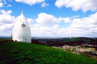 White cone shaped structure on a hillside