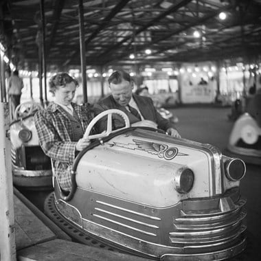 A couple driving in a dodgem car