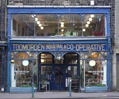 Glass shopfront with wording 'Todmorden Industrial & Co-operative Society Limited' above the door
