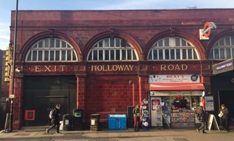 Red-tiled exterior of underground station. Signage on the station reads: 
'Exit - Holloway - Road'