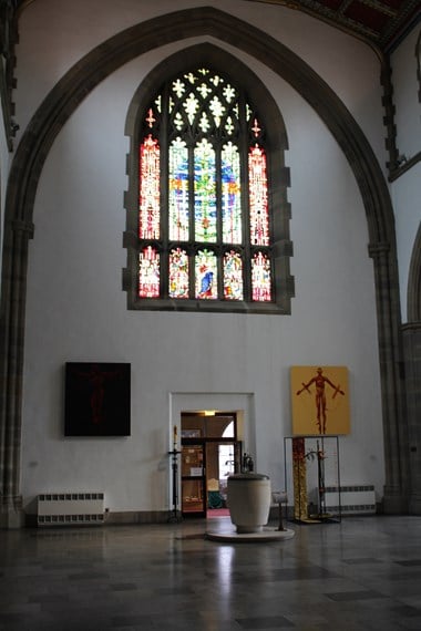 Image of the font at Blackburn Cathedral, also showing the entrance to the Cathedral shop.