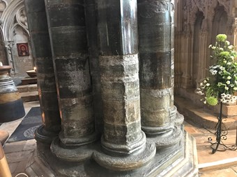 a block of four visible stone columns inside a church building