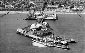 Aerial view of pier with paddle steamers moored at the end of it