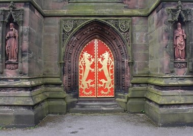 Arched doors decorated with gold lions and a red background