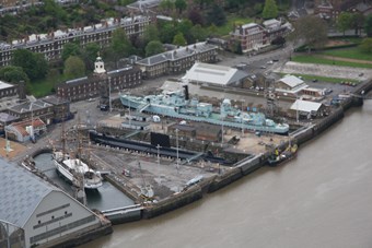 Aerial view of a sailing ship, submarine and destroyer in dry dock