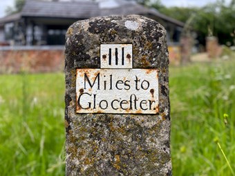 A milestone which reads '111 miles to Gloucester'