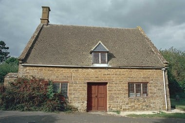 Single storey stone building with dormer window in roof