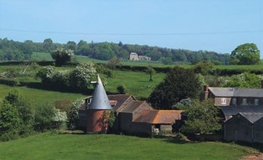 The hop kiln settled in the landscape.