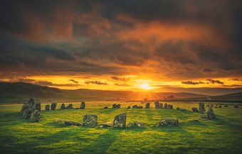Stone circle with the sun rising in the background