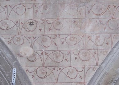 Masonry pattern with foliate scrollwork typical of the 14th century.
