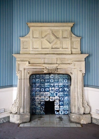 A fireplace with Delft tile insert.