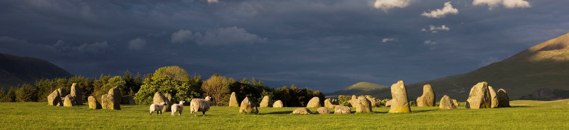 The prehistoric stone circle at Castlerigg with dark skies in the background