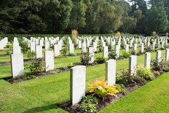 Colour photograph showing rows of well tended gravestones 