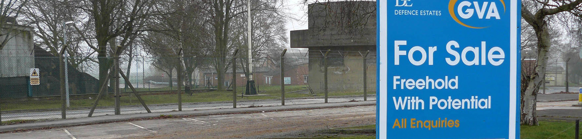 Copenacre, Wiltshire, former Royal Navy stores depot and administrative centre showing a for sale sign outside of the fenced base.