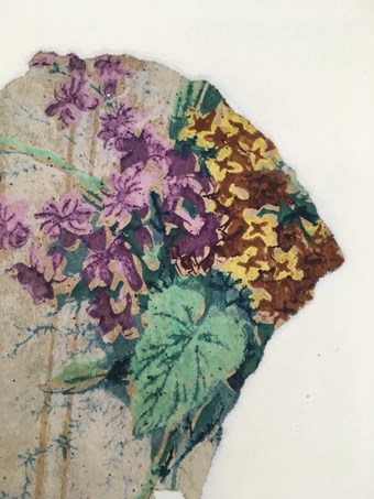 A detail of a historic wallpaper featuring a floral arrangement including mauve and yellow flowers. The green pigment contain arsenic.