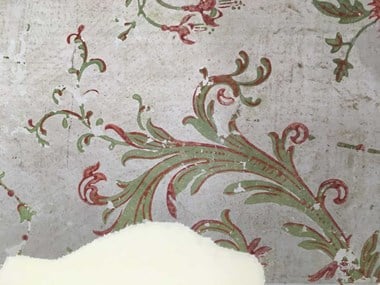 A historic wallpaper featuring a green floral pattern with red flowers. The green pigment contains arsenic.