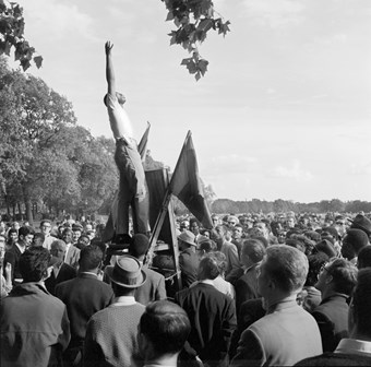 General view of a crowd at speakers corner in Hyde Park, with a young black man on the platform with arm outstretched to the sky.  'london observed' negatives hyde park speakers corner greater london city of westminster paddington bayswater and knightsbridge