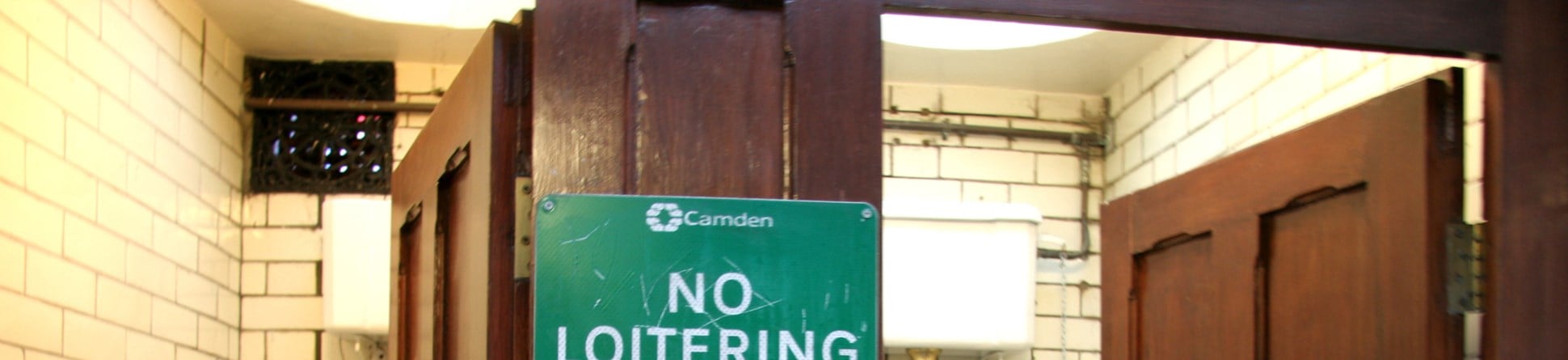 'No Loitering' sign in toilets