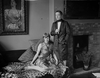 Radclyffe Hall and Una Troubridge in evening dress at their home.