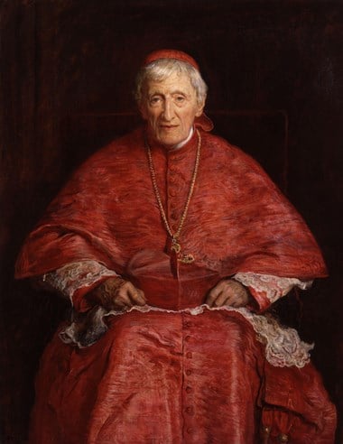 Portrait of John Henry Newman seated wearing red robes.