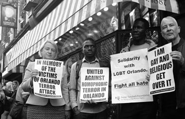 People stand in remembrance and solidarity with the victims of the Orlando LGBTQ club massacre