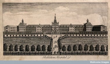 The Hospital of Bethlem [Bedlam] at Moorfields, London: seen from the north, with ladies and gentlemen walking in the foreground, one giving money to a cripple. Engraving by W. H. Toms. 