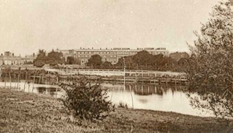 Exterior view looking across the river towards the palace. Hampton Court Palace, 1870