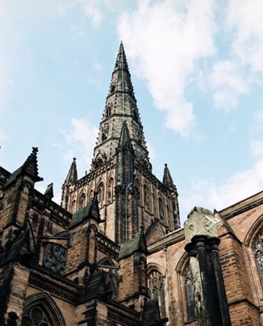 Exterior view looking up at the spire of Lichfield Cathedral, Cathedral Church Of The Blessed Virgin Mary And St Chad, The Close, Lichfield, Staffordshire from where a deaf soldier shot a member of Cromwell's army during the Civil War.