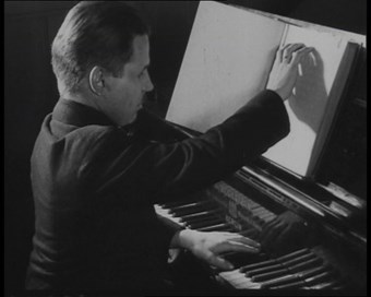 A still of a blind pianist from the film 'Blind People Working' (c. 1910-1929)