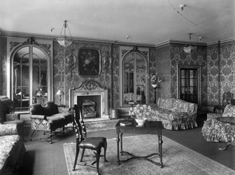 Elaborately decorated room with sofas, armchairs, and table