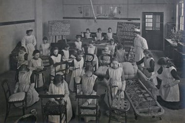 An upholstery class at Ancona Road, Woolwich, London Half Time Class for girls who worked part time and attended school part time, c.1890-1905. © & source The Women’s Library.