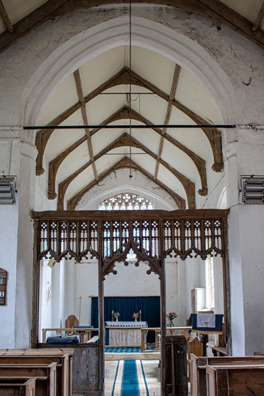 Internal photo of a church, showing the aisle.