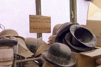 Dusty bowler hats sit forgotten inside Boon & Lane, a blockmakers in Luton