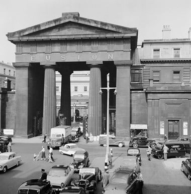 Archive photograph showing the triumphal arch with traffic on adjoining roads