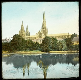 Archive photo showing a cathedral with a spire reflected in a lake.