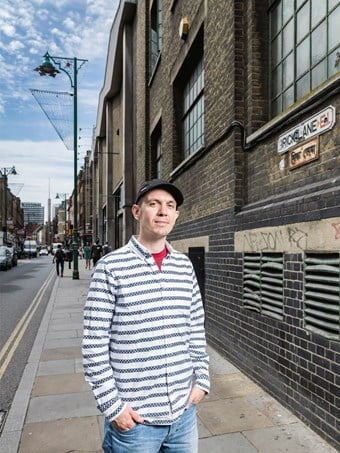 Martyn Hayes standing with hands in pockets on Brick Lane, London.