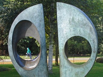 Sculpture with two circles through which a cyclist can be seen