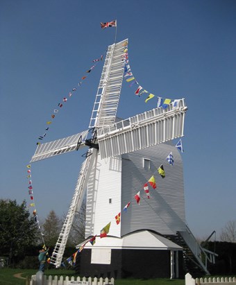 Windmill with bunting on the sails