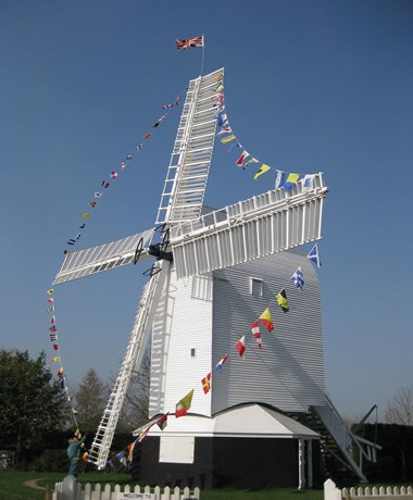 Windmill with bunting on the sails