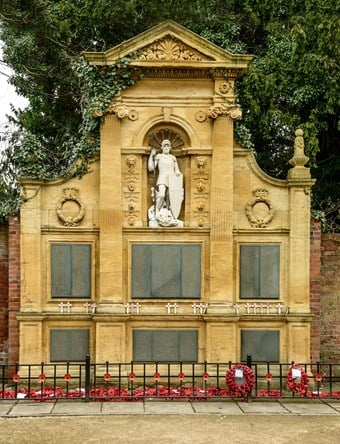 Image of Lichfield War Memorial, Bird Street, Lichfield, Staffordshire, newly upgraded to II*. Lichfield retains strong connections with the Army and this memorial, set in a Garden of Remembrance opened in 1920, honours the high casualties suffered by the city. The Renaissance-inspired screen features a statue of St George triumphant over a slain dragon – the classic story of good triumphing over evil.