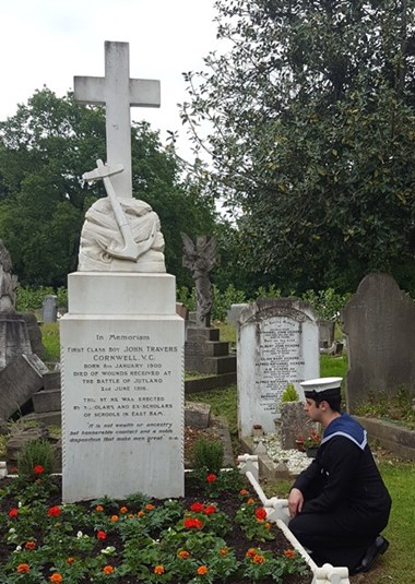 Able Seaman Alexander Saridis, Great-Great Nephew of Jack Cornwell pays respect graveside. © Historic England